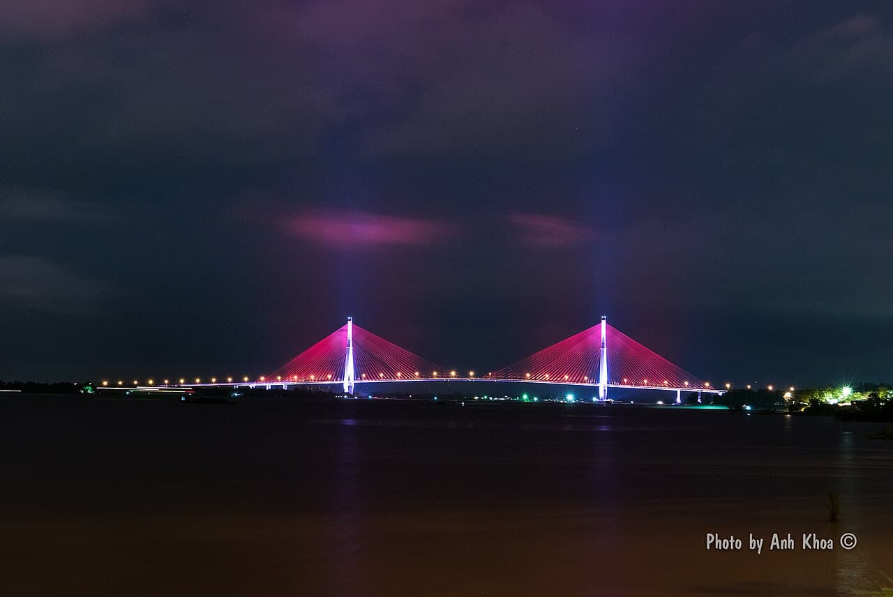 Can Tho Bridge illuminated in pink across the Bassac River at night