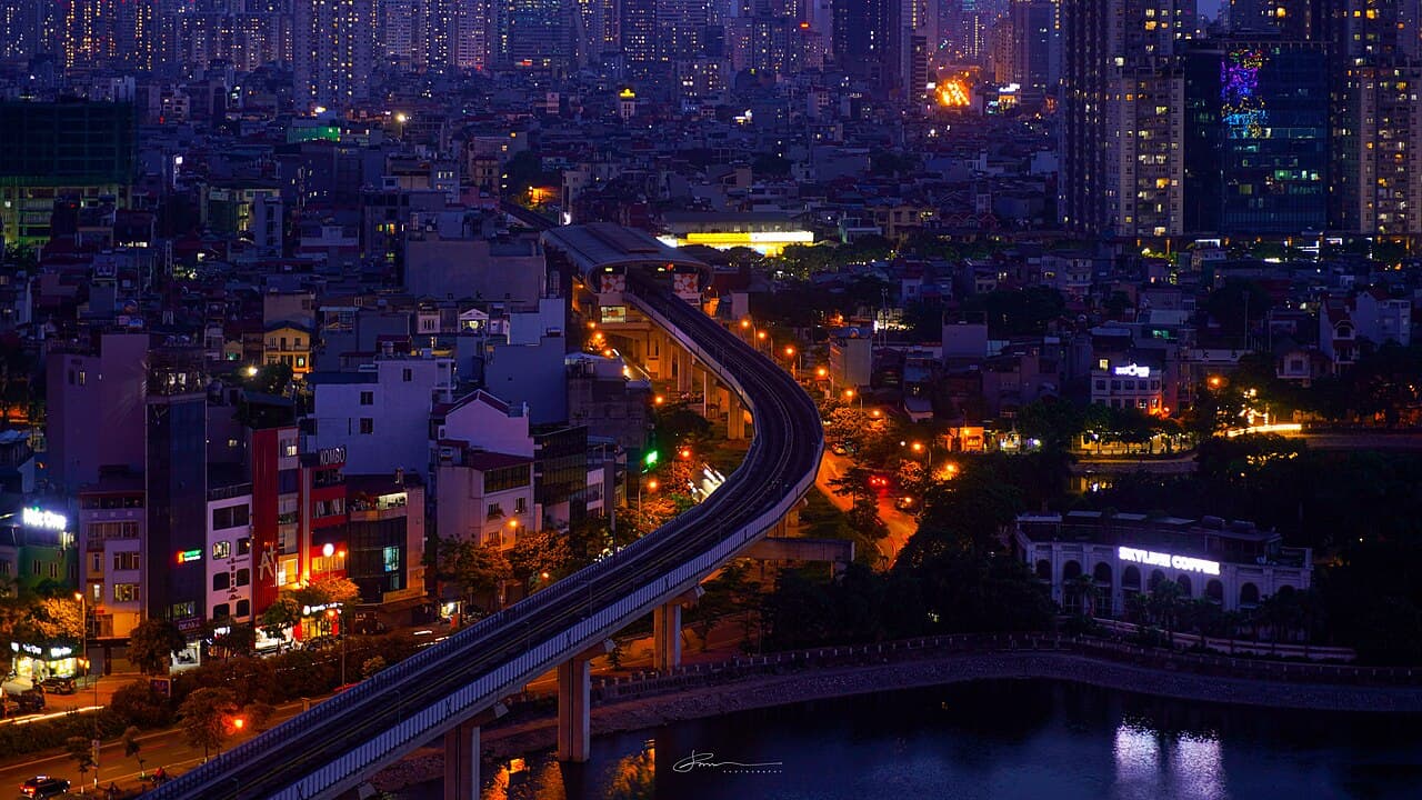 Elevated railway and illuminated buildings in Hanoi's Dong Da district at night
