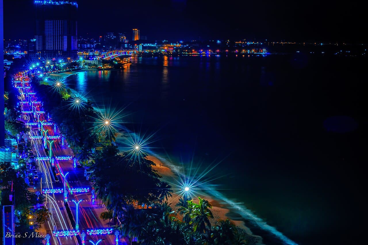 Nha Trang's illuminated beachfront and curving coastline at night
