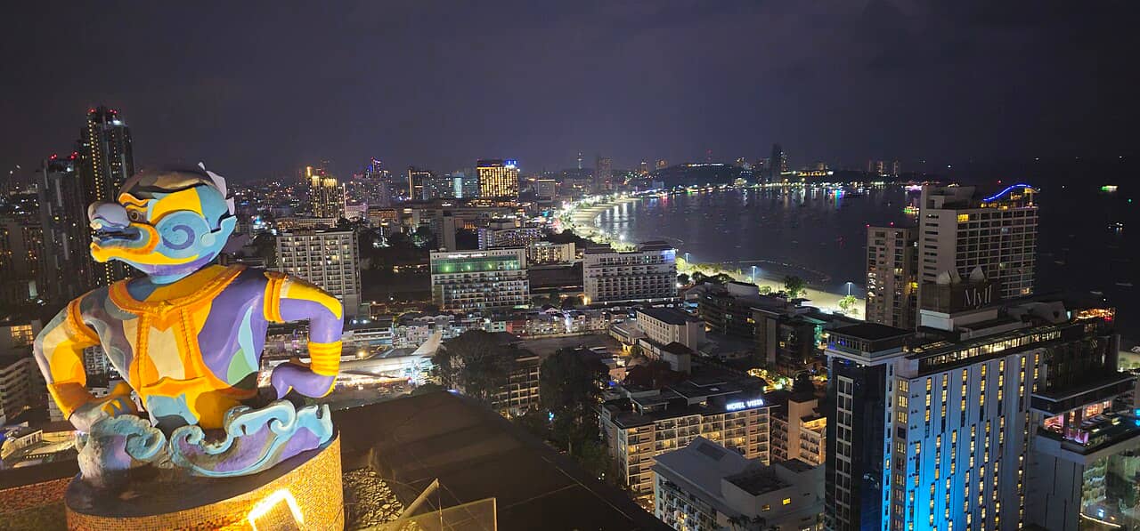 Pattaya's illuminated bay and city buildings at night