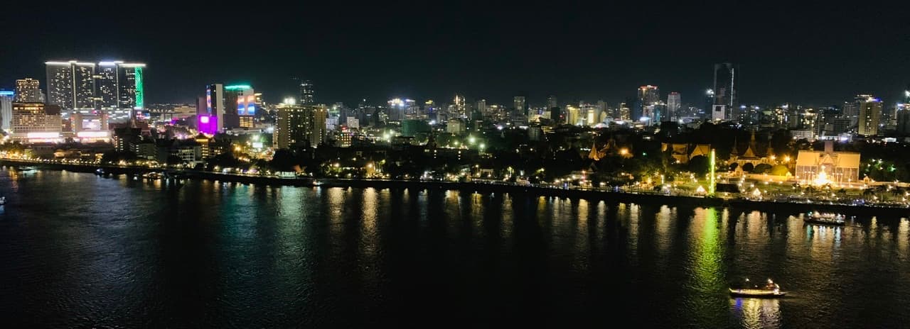 Phnom Penh's illuminated riverfront viewed from the east at night